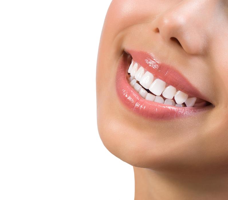 A woman smiling after getting Porcelain Dental Crowns in Rockville, MD